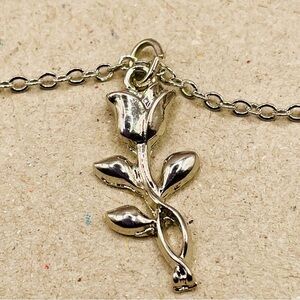 Urban Outfitters Silver rose flower pendant on a silver tone chain. Minimal.